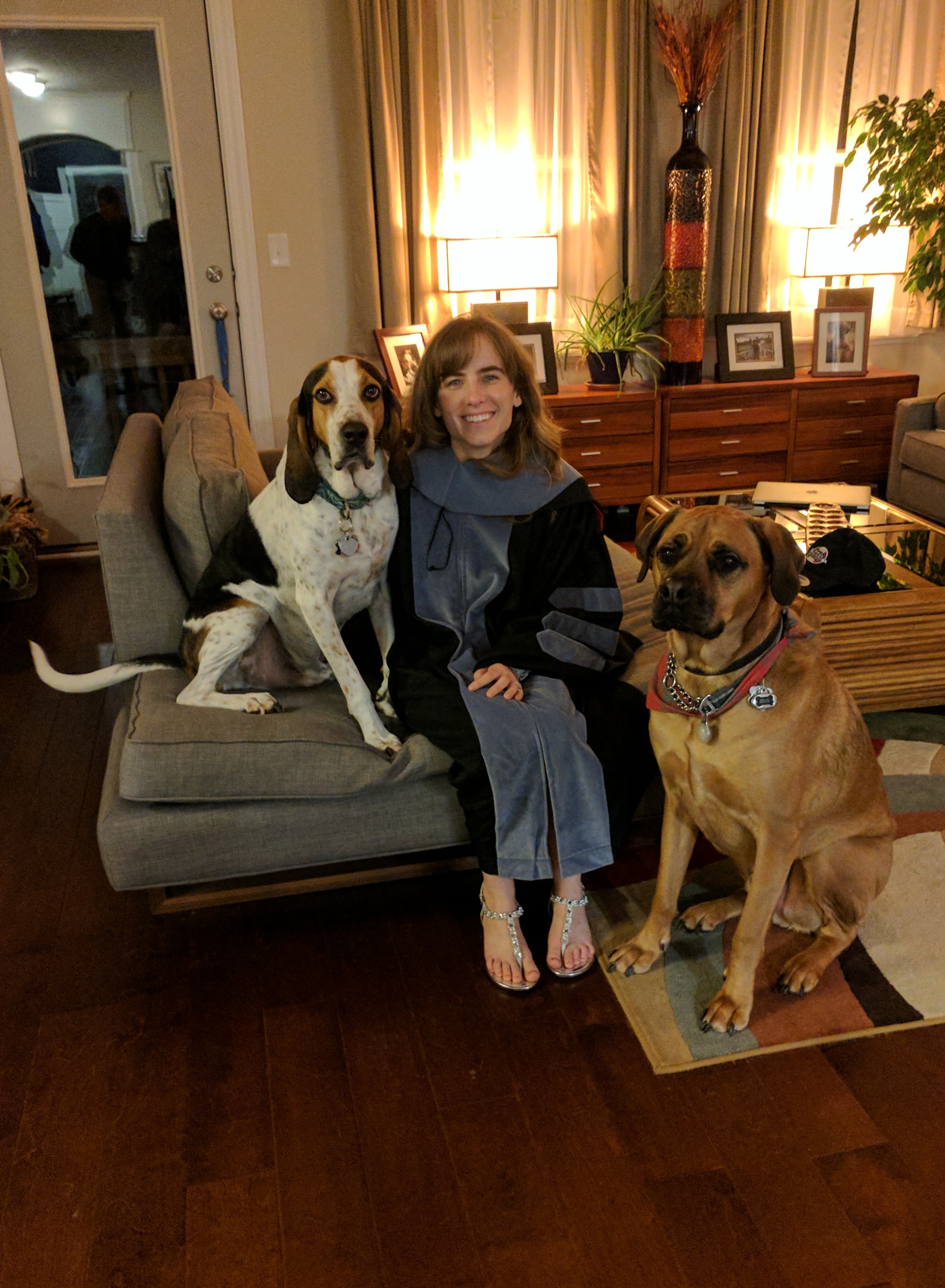 Sara with pets in graduation attire